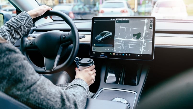 Rear inside view of person driving an electric car.